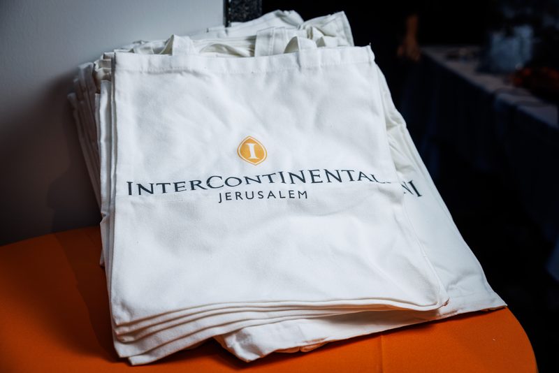 A stack of branded tote bags
