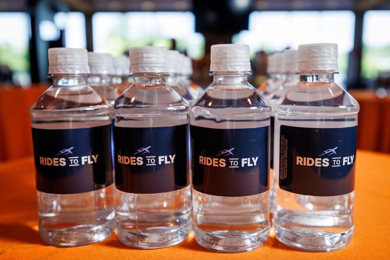 Branded water bottles on an orange table