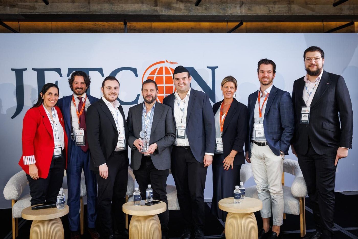 Nine Jetcon speakers on stage in front of the Jetcon backdrop at the 2026 show